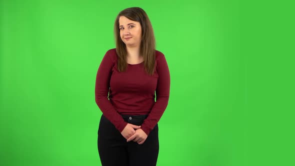 Pretty Girl Is Smiling and Shrugging. Green Screen