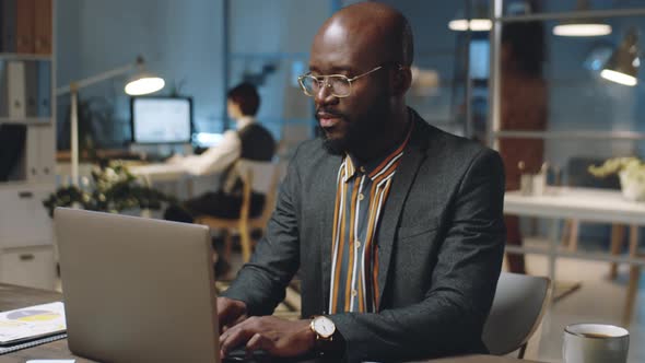 African American Businessman Using Laptop at Work in Office