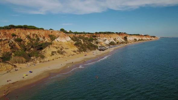 Aerial. Beach of Falesia and Tourists Are Resting. View From the Sky.