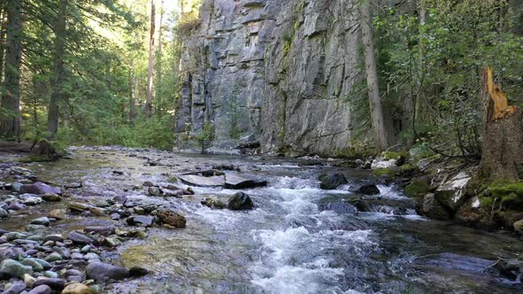 Rapids Over Smooth Mossy Rocks On River Creek In Forest. Low Aerial