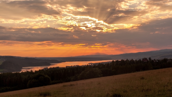 Sunset Over a Mountain and Forest Lake