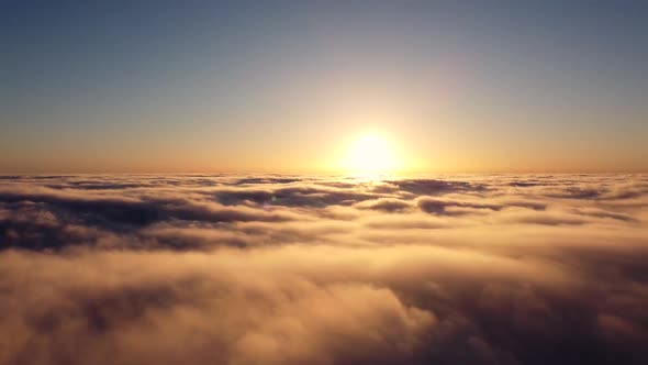 a Timelapse Flight Over the Clouds Early in the Morning When the Sun Rose on the Horizon