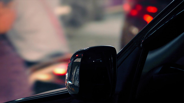 Car At Night With Passing Traffic And People