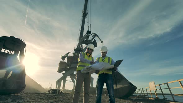 Two Engineers Are Having a Discussion Near the Construction Site, Quarry