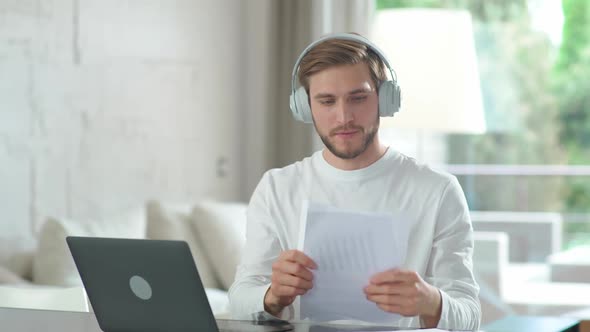 Young Caucasian Manager Communicates with Colleagues By Video Call Using a Laptop Man on Remote Work