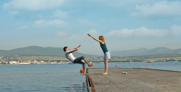 A Girl Is Pushing Away A Boy Into the Water