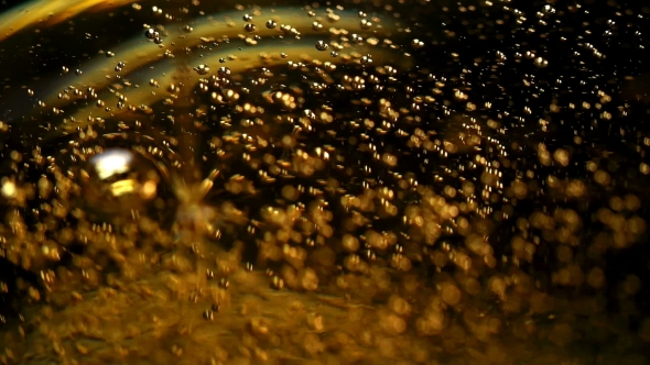 Oil Pours Into the Dishes Forming Bubbles
