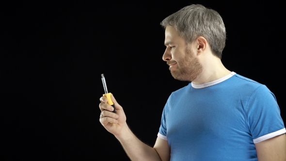 Cheerful Handsome Man in Blue Tshirt Holds Screwdriver
