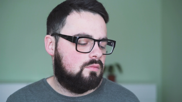 Tired Man in Glasses Looking To Camera in