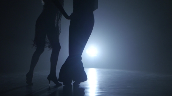 Dance Couple Demonstrating Magnificent Choreography of Cha-cha, Black Background. Close-ups