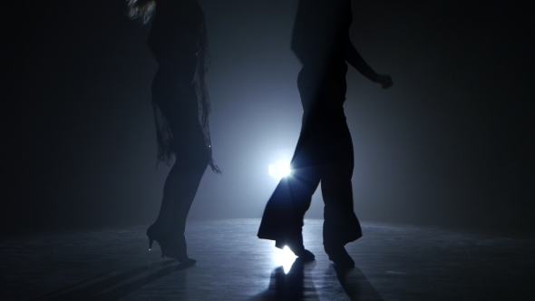 Dance Couple Demonstrating Magnificent Choreography of Quickstep, Black Background. Close-ups