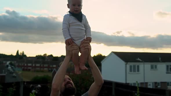 Happy Father Holding Adorable Baby Boy Embracing Kissing