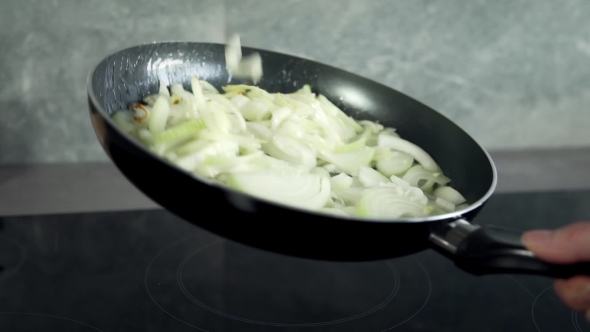 Chef Fryes Onion in a Hot Frying Pan, Vegetables Are Cooked, Meals with Vegetables