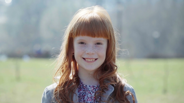 Little Ginger Girl with Freckles Smiling, Spring Day