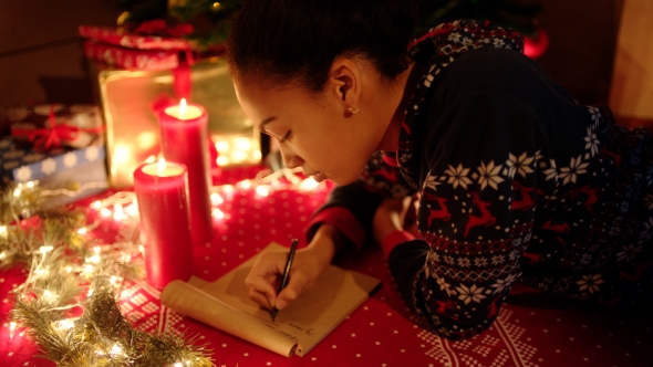 Teen Girl Is Lying and Writing a Letter To Santa Claus on New Years Eve