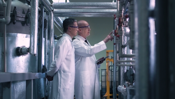 Scientists Talking and Touching Valve