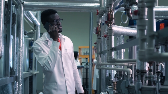 Scientist Talking Phone on Factory alt