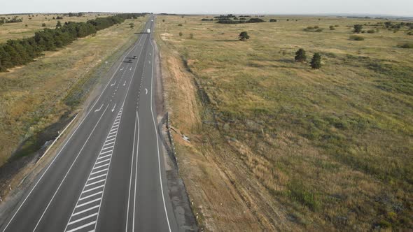 Aerial View of a Highway Going Through the Field.