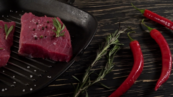 Beef Fillet on a Pan with Pepper, Rosemary and Garlic.