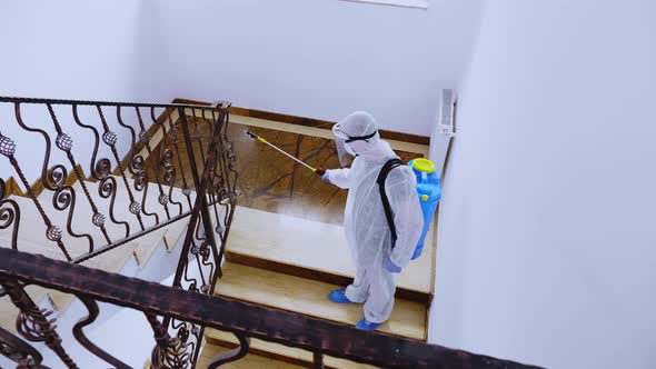 Biologist in Full Hazmat Suit Sprays Disinfectant