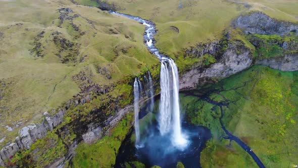 Waterfalls in green mountainous terrain