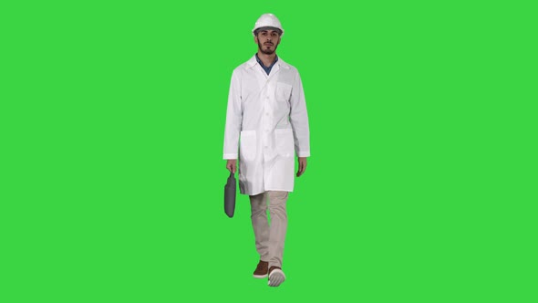 Professional Engineer with Suitcase and in Helmet Walking on a Green Screen, Chroma Key