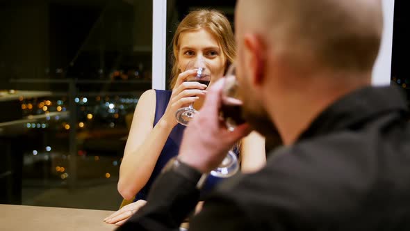 Couple toasting glass of wine while having dinner