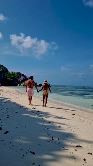 Anse Source d'Argent La Digue Seychelles Young Couple Men and Woman on a Tropical Beach During a