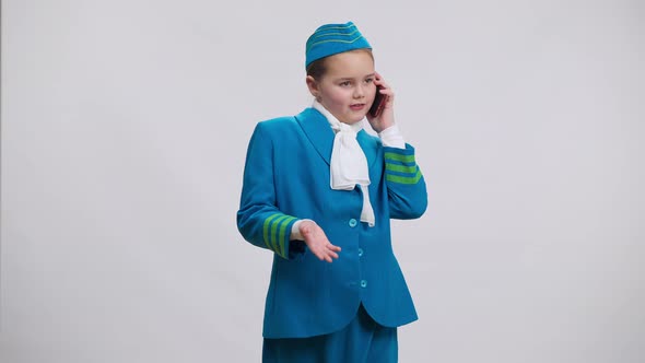 Cute Pretty Girl in Stewardess Uniform Talking on Phone Gesturing Standing at White Background