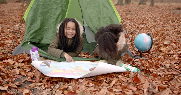 Black Girls Looking at Map in the Autumn Forest