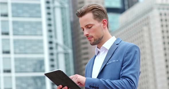 Businessman work on tablet computer in city