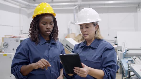 Middle Aged Female Engineer Showing Machines