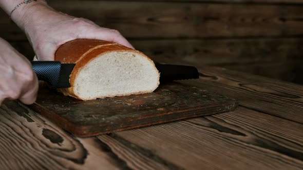 Cutting Fresh Wheat Bread with a Special Knife