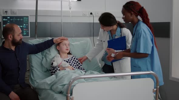 Sick Patient Resting in Bed Wearing Oxygen Nasal Tube Discussing with Pediatrician Doctor