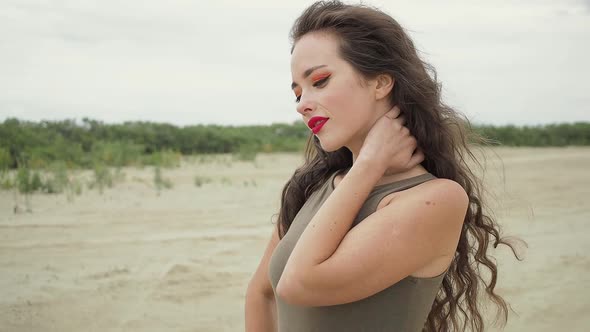 Pretty Woman Touching Hair on Beach