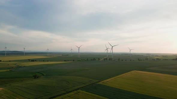 Windmill Turbines at Sunset Wind Energy Concept