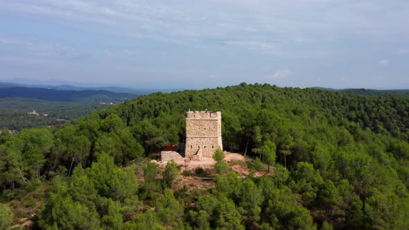 Beautiful historic European Stone watchtower in the middle of a dense beautiful Green forest surroun