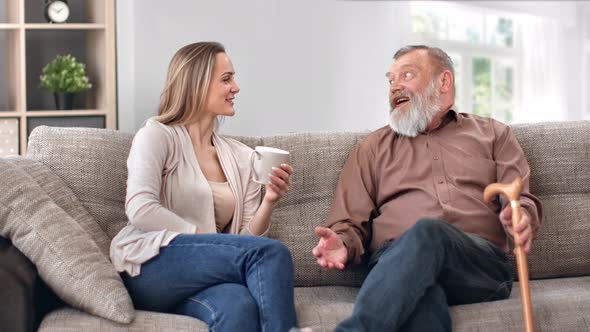 Happy Family Relatives Granddaughter Daughter and Father Grandfather Relaxing at Home Talking