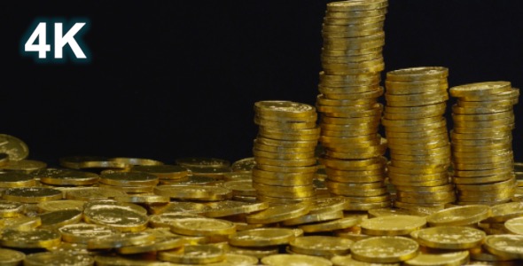 Gold Coins Stacked In Stakes