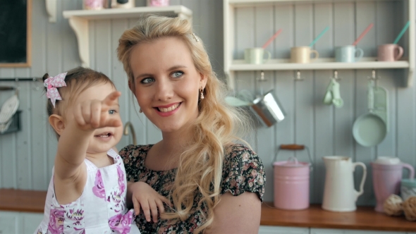 Young Mother Holding Her Newborn Child Girl. Family at Home Near Window, Beautiful Young Mom