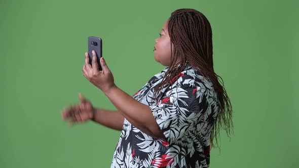 Overweight Beautiful African Woman Against Green Background