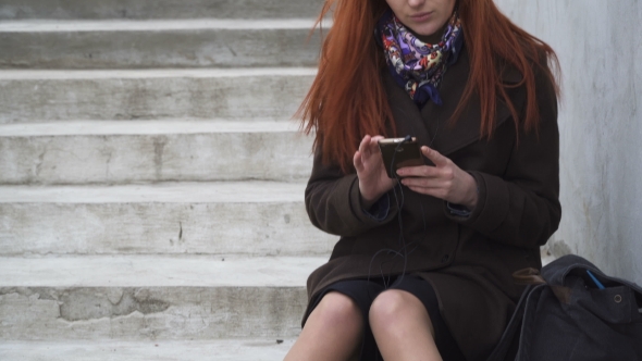 Woman with Headphones and Smartphone