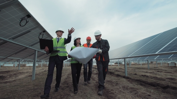 People Walking in Solar Panels and Talking