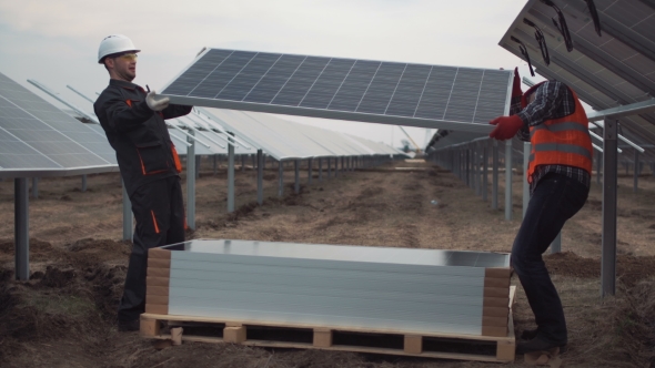 People Mounting Solar Panels