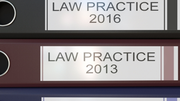 Vertical Stack of Multicolor Office Binders with Law Practice Tags Different Years