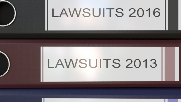 Vertical Stack of Multicolor Office Binders with Lawsuits Tags Different Years alt