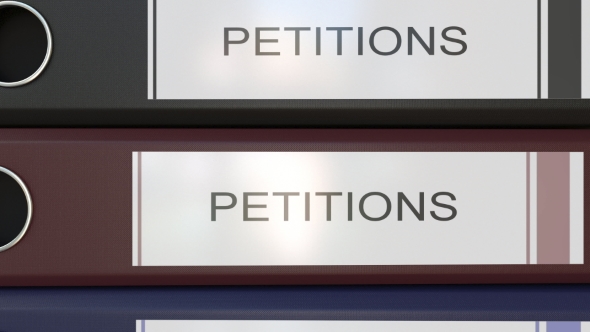 Vertical Stack of Multicolor Office Binders with Petitions Tags alt
