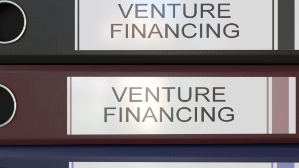 Vertical Stack of Multicolor Office Binders with Venture Financing Tags alt