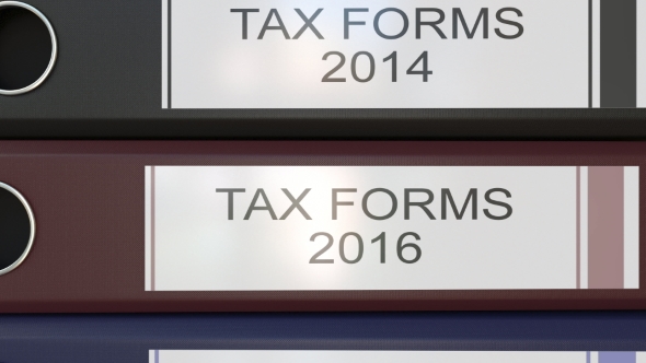 Vertical Stack of Multicolor Office Binders with Tax Forms Tags Different Years