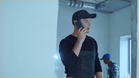 Man Walking on Site and Talking Phone alt